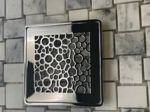 Bubbles Wedi Drain Kit Polished Nickel on tile.