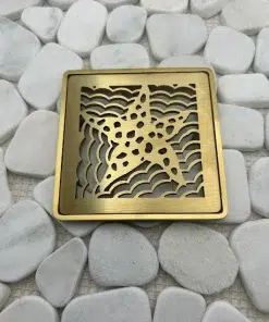 Square drain with brushed brass finish.