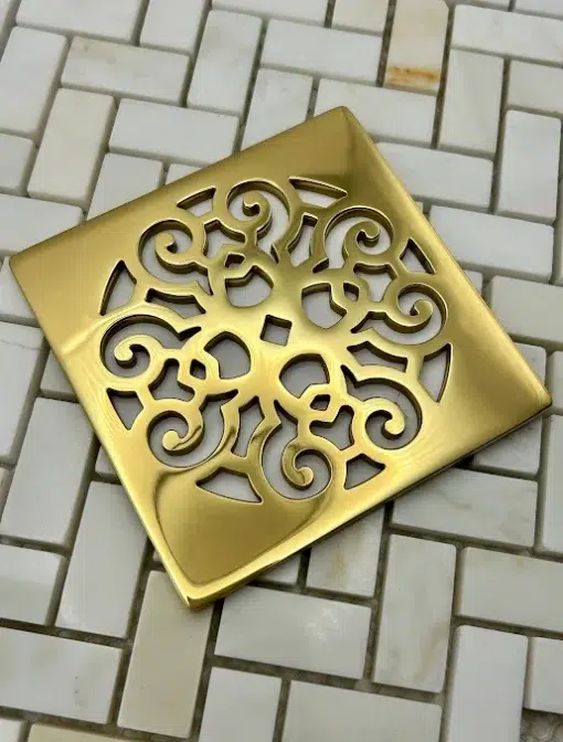 Square drain with polished brass finish.