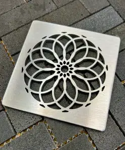 Square drain with a brushed stainless steel finish.