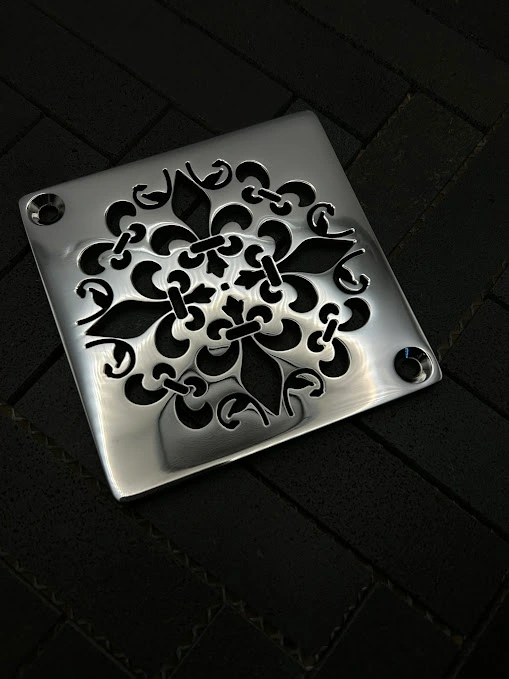 Square Mon Fleur drain with polished stainless steel finish.