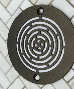 Geometric Maze oil rubbed bronze finish on white tile