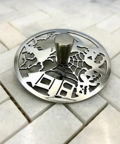 Round Sink Strainer with trick or treat design in polished stainless steel finish.