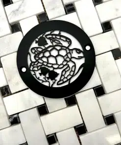 Round drain with turtle design in matte black finish.