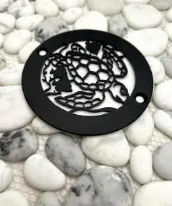 Round drain with turtle design in matte black finish.