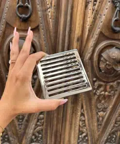 Square drain with polished stainless steel finish.