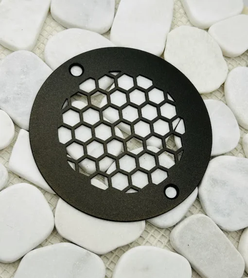 Round drain with oil rubbed bronze finish.