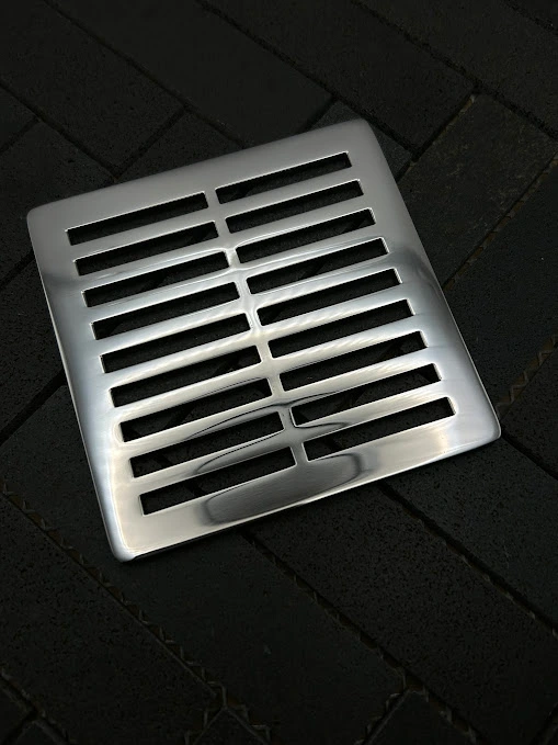 Square Parallels drain with polished stainless steel finish.