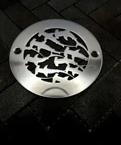 Round drain with Sharks design in polished stainless steel finish.