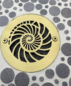 Nautilus Design 4 inch Round Brushed Brass on tile Designer Drains.