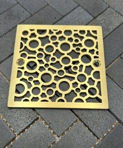 Square drains with brushed brass finish.