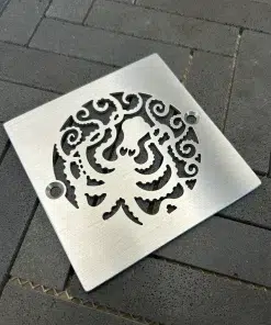 Square drain with octopus design and a brushed stainless steel finish.