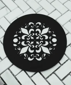 Fleur De Lis 4.25 round shower drain in matte black on tile