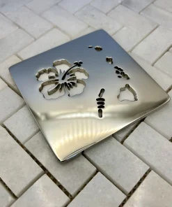 Square drain with Hawaii design in polished nickel finish. Compatible with Schluter Trendline.