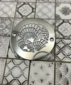 Round drain in polished stainless steel finish.