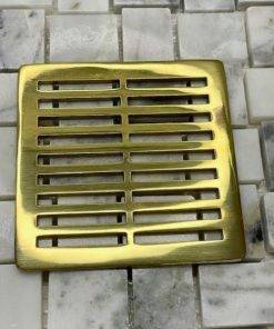 Parallel shower drain made to fit Wedi polished brass by Designer Drains