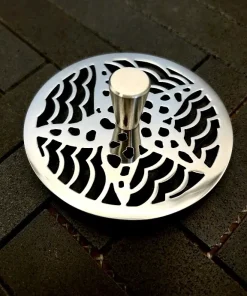 Round sink strainer with starfish design in polished stainless steel finish.
