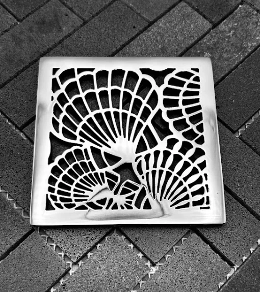 Square drain with polished stainless steel finish.