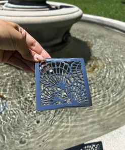 Square drain with polished stainless steel finish.