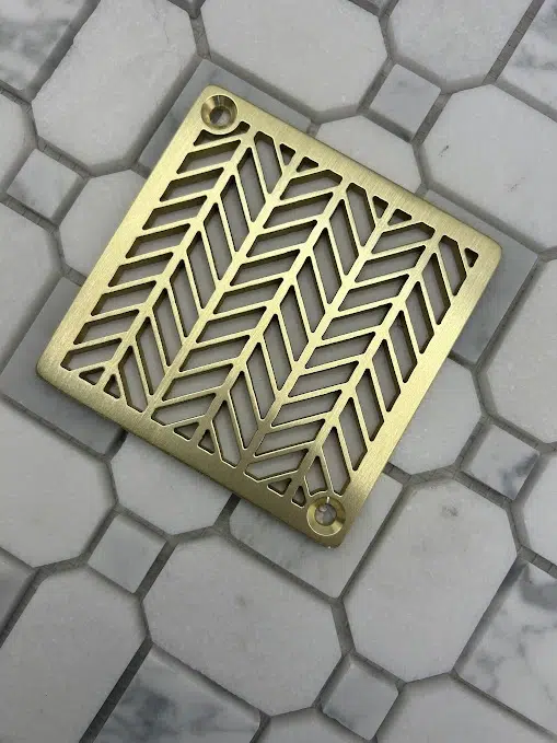 Square drain with unlaquered brushed brass finish.