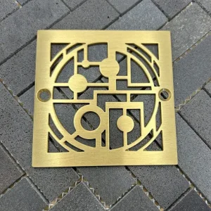 Square drain with brushed brass finish.