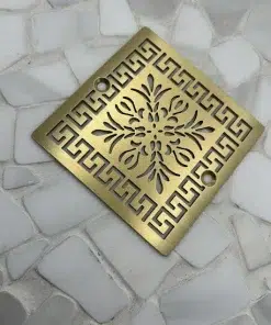 Square drain with brushed brass finish.