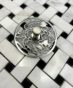 Round sink strain with turtle design in polished stainless steel finish.