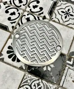 Round drain in polished stainless steel finish.