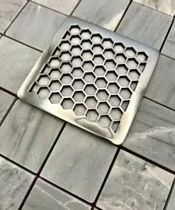 Square drain in honeycomb design with polished stainless steel finish.