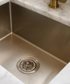 Greek Anthemion Sink strainer in a brushed sink.