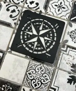compass rose design in matte black finish on black decor tile