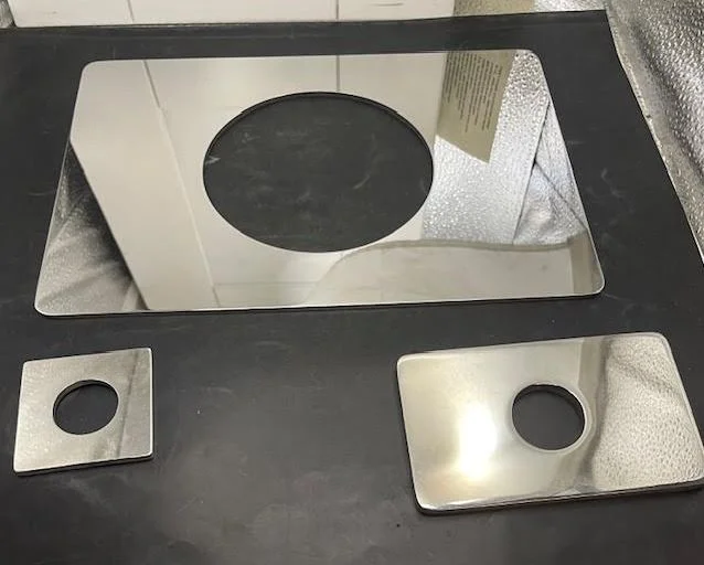 Oversized escutcheon plate covering large shower valve opening