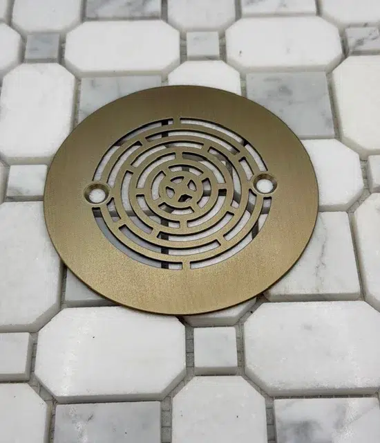 Geometric Maze 4.25 inch round shower drain in champagne bronze finish.